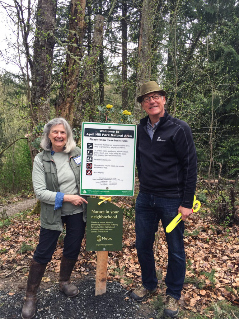 Jill and a man standing by the AHP sign